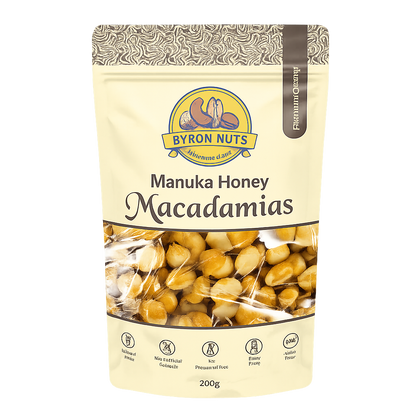 Raw Byron Bay Nuts Manuka Honey Macadamia nuts in a clear container, showcasing their golden-brown color and crunchy texture.